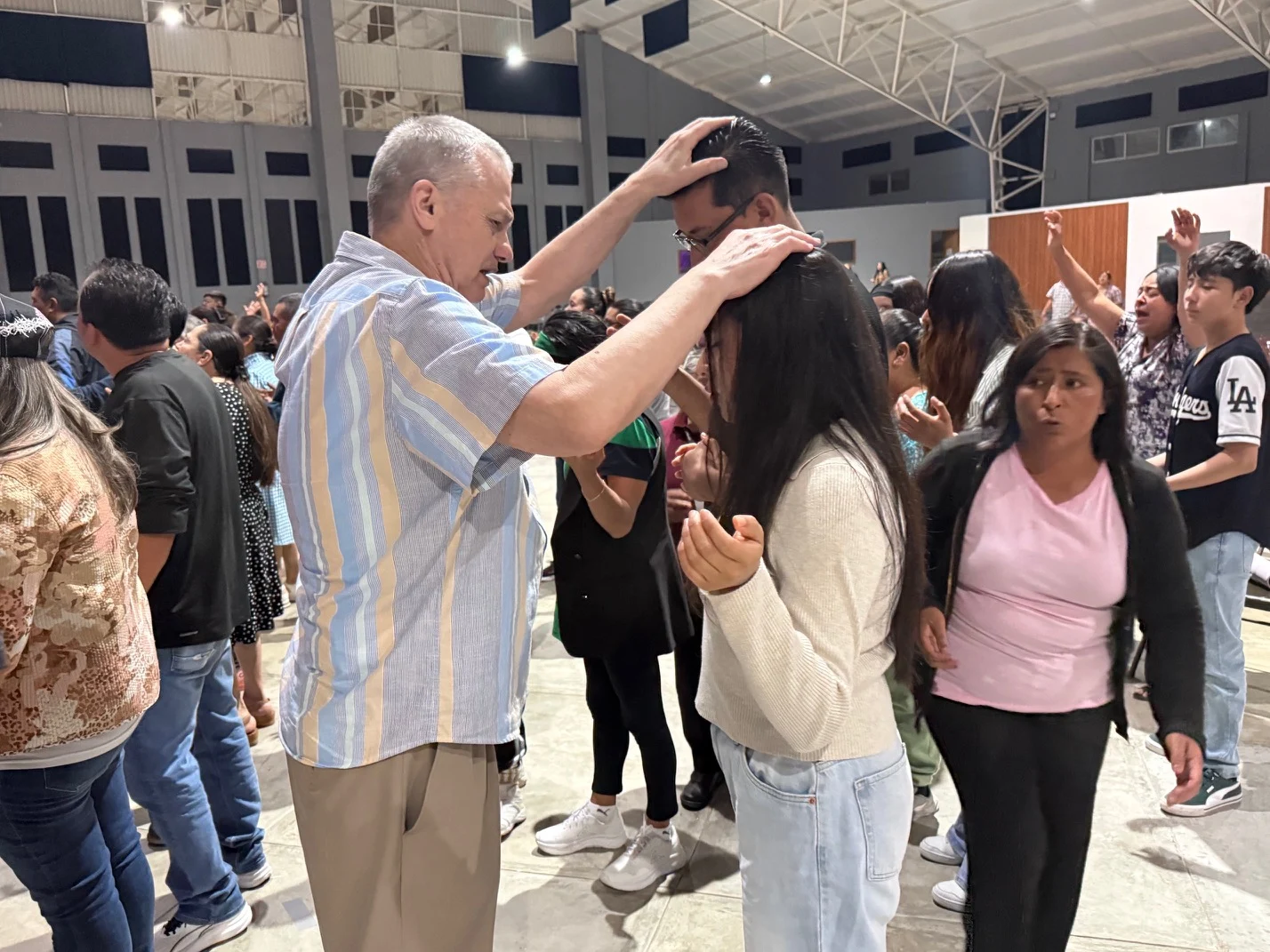 Terry praying with people in Mexico City